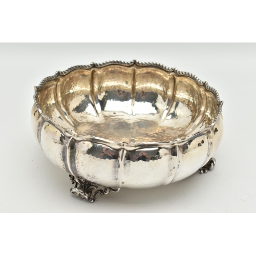 105 - A WHITE METAL BOWL, a large bowl raised on three feet, hammered finish with twisted rope detail, app... 