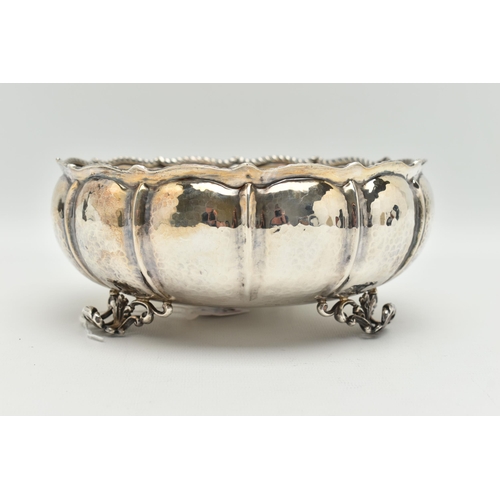 105 - A WHITE METAL BOWL, a large bowl raised on three feet, hammered finish with twisted rope detail, app... 