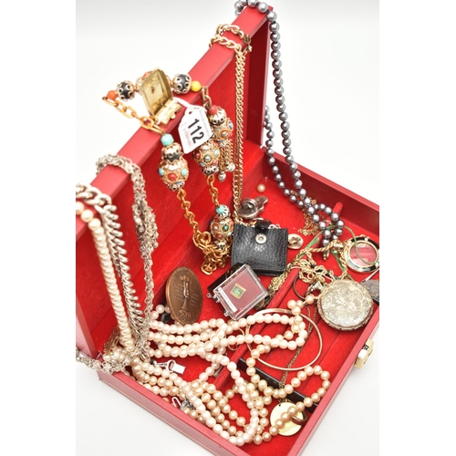 112 - A RED JEWELLERY BOX WITH CONTENTS, to include imitation pearl necklaces, costume chains, novelty Mon... 