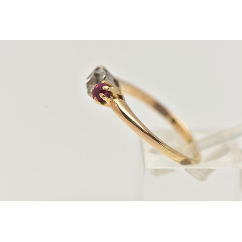 153 - A YELLOW METAL DIAMOND AND RUBY THREE STONE RING, centering on an old cut diamond, estimated diamond... 