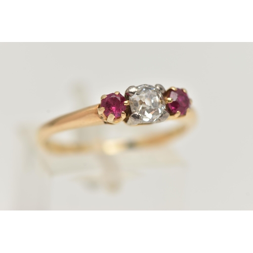 153 - A YELLOW METAL DIAMOND AND RUBY THREE STONE RING, centering on an old cut diamond, estimated diamond... 