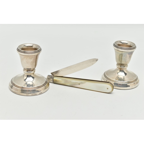 94 - A PAIR OF SILVER DWARF CANDLE STICKS AND A FRUIT KNIFE, polished tapered candle sticks, on round wei... 