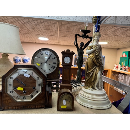 420 - A GROUP OF CLOCKS AND FIGURAL LAMP BASES, comprising a pocket watch and stand, the continental pocke... 