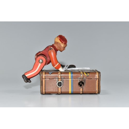 337 - A GESCHA TIN PLATE 'EXPRESS BOY' CLOCKWORK TOY, the boy wearing a red uniform, pushing a trunk, mark... 