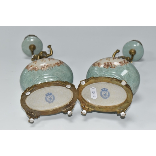 393 - A PAIR OF REPRODUCTION TURQUOISE PORCELAIN AND BRASS FIGURAL CANDLEHOLDERS OF LATE 19TH CENTURY STYL... 