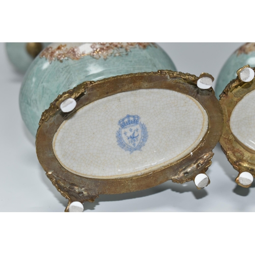 393 - A PAIR OF REPRODUCTION TURQUOISE PORCELAIN AND BRASS FIGURAL CANDLEHOLDERS OF LATE 19TH CENTURY STYL... 