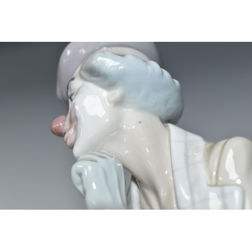 447 - A LLADRO CLOWN, no 4618, designed by Salvador Furio in 1970, the figure lying on his front with head... 