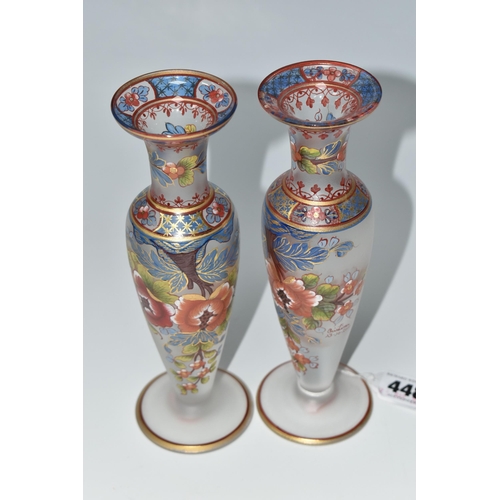 448 - TWO ATLANTIS GLASS FOOTED VASES, painted with flowers and foliate or geometric borders, having gilt ... 