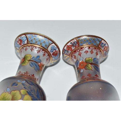 448 - TWO ATLANTIS GLASS FOOTED VASES, painted with flowers and foliate or geometric borders, having gilt ... 