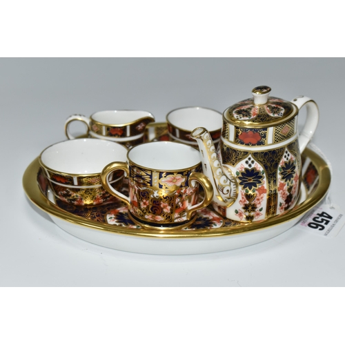 456 - A MINIATURE ROYAL CROWN DERBY IMARI 1128 TEA SET AND SERVING TRAY, comprising an oval serving tray, ... 