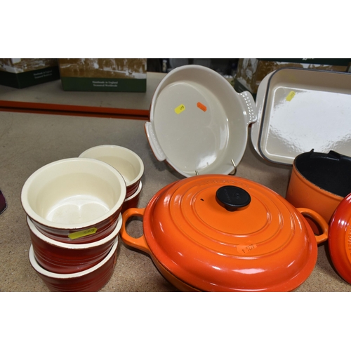 469 - A GROUP OF LE CREUSET VOLCANIC ORANGE PANS AND OVENWARE, comprising two saucepans  size 16, a covere... 