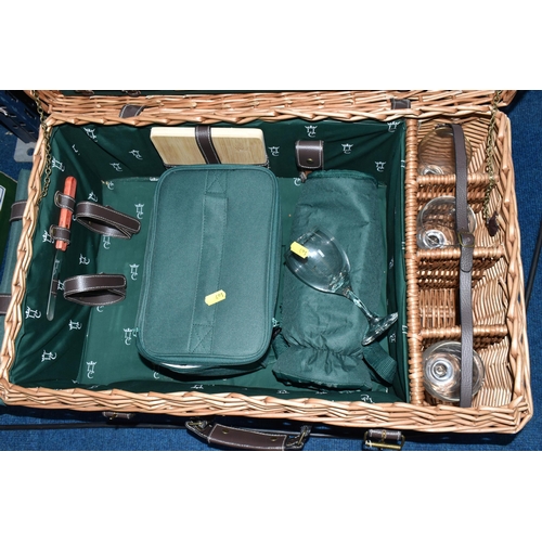 491 - A WICKER PICNIC HAMPER/SET, a large hamper containing a set of four wine glasses, four plates, cutle... 