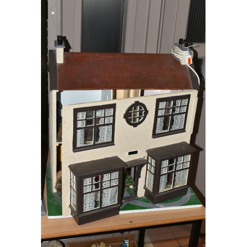 518 - TWO DOLL'S HOUSES, comprising a large Georgian kit built house, partially decorated, and a mid twent... 