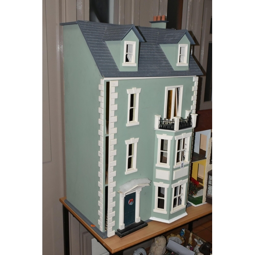 518 - TWO DOLL'S HOUSES, comprising a large Georgian kit built house, partially decorated, and a mid twent... 