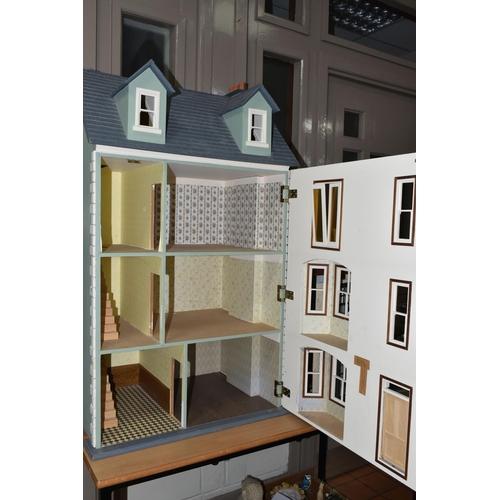 518 - TWO DOLL'S HOUSES, comprising a large Georgian kit built house, partially decorated, and a mid twent... 