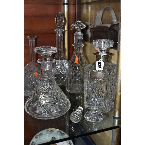 535 - A GROUP OF DECANTERS AND STOPPERS, comprising a square decanter with silver collar, hallmarked Birmi... 