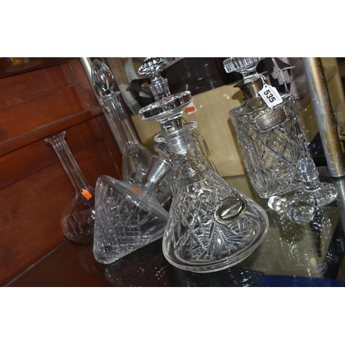 535 - A GROUP OF DECANTERS AND STOPPERS, comprising a square decanter with silver collar, hallmarked Birmi... 