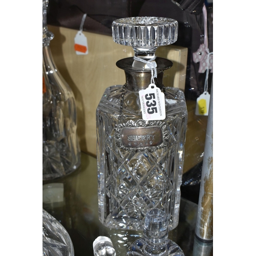 535 - A GROUP OF DECANTERS AND STOPPERS, comprising a square decanter with silver collar, hallmarked Birmi... 