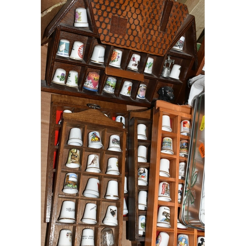 548 - A CERAMIC THIMBLE COLLECTION, to include over one hundred and fifty thimbles in wooden wall hanging ... 