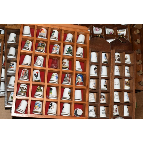 548 - A CERAMIC THIMBLE COLLECTION, to include over one hundred and fifty thimbles in wooden wall hanging ... 