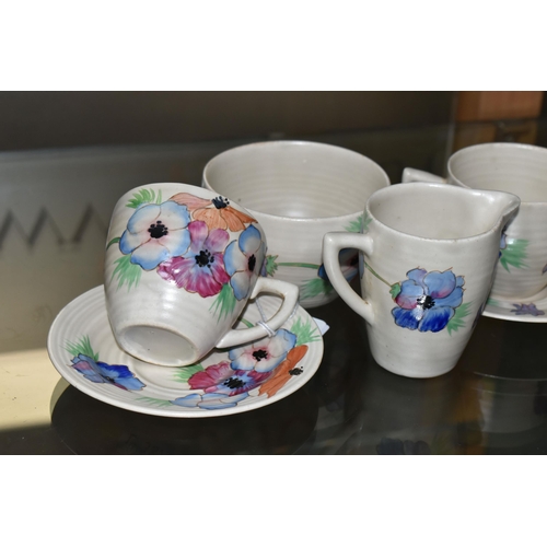 644 - A SIX PIECE CLARICE CLIFF 'ANEMONE' PART TEA SET, comprising two teacups and saucers, a cream jug an... 