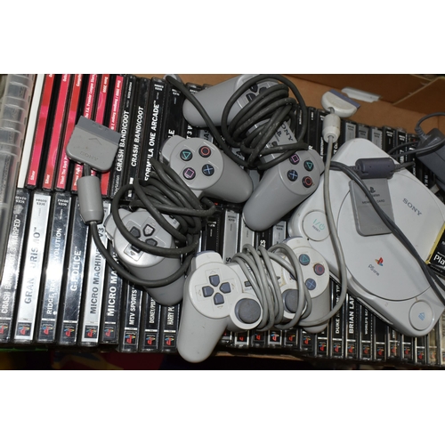 696 - A SONY PLAYSTATION ONE CONSOLE AND GAMES, has over fifty games including Crash Bandicoot (big box), ... 