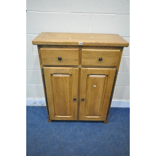 1322 - A SOLID OAK CABINET, fitted with two drawers, above two cupboard doors, width 84cm x depth 35cm x he... 