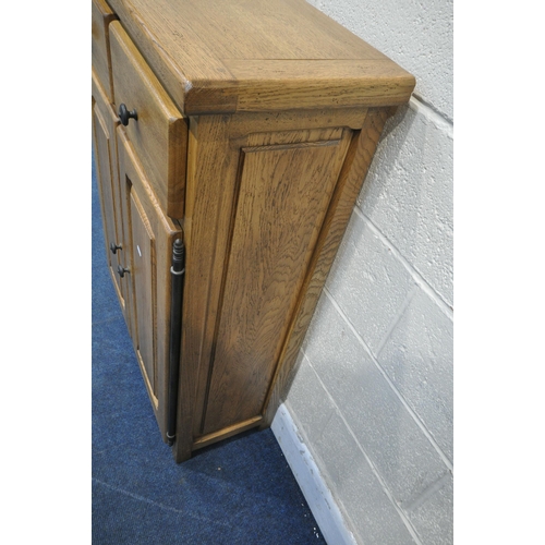 1322 - A SOLID OAK CABINET, fitted with two drawers, above two cupboard doors, width 84cm x depth 35cm x he... 