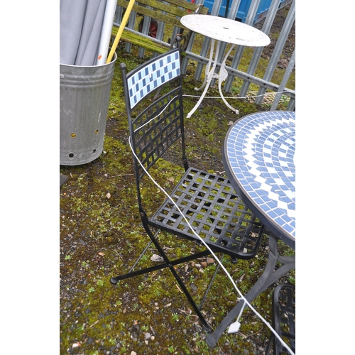 1010 - A STEEL AND TILED TOP GARDEN TABLE with four similar folding chairs table diameter 90cm