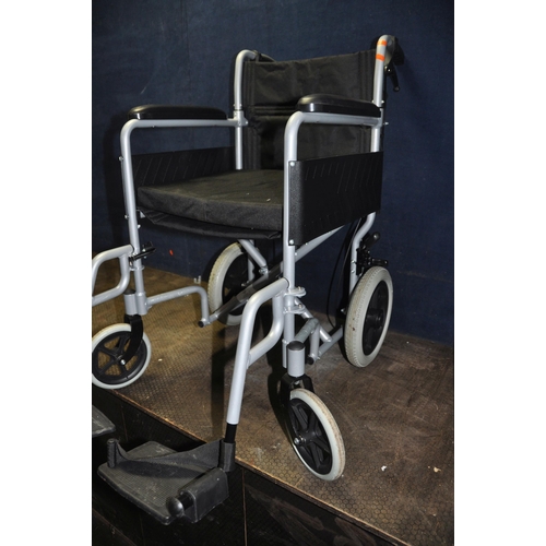 1079 - AN ANGEL MOBILITY FOLDING WHEEL CHAIR with seat pad and two footrests