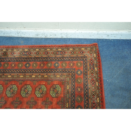 1335 - A RED GROUND TABRIZ WOOLLEN RUG, with forty eight central medallions, surrounded by a multi-strap bo... 