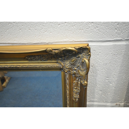 1352 - A RECTANGULAR GILT RESIN BEVELLED EDGE WALL MIRROR, with foliate details,108cm x 77cm, along with an... 