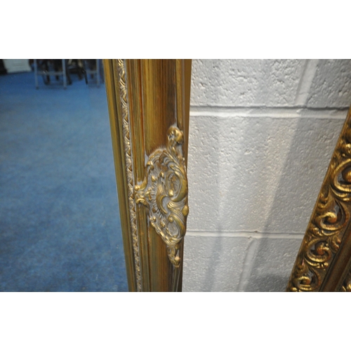 1352 - A RECTANGULAR GILT RESIN BEVELLED EDGE WALL MIRROR, with foliate details,108cm x 77cm, along with an... 