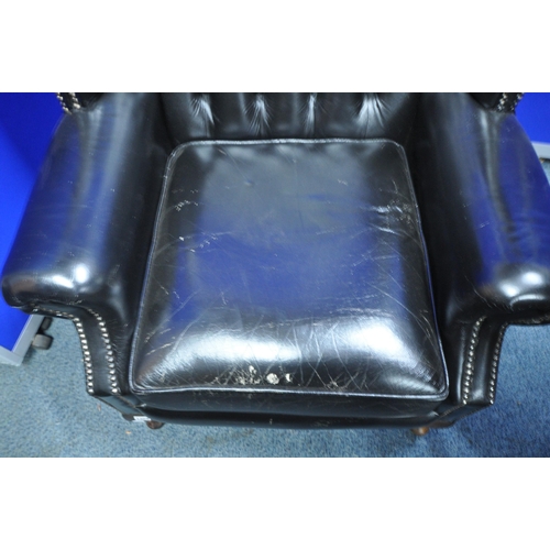 1359 - A BLACK LEATHER UPHOLSTERED BUTTONED WINGBACK CHESTERFIELD STYLE ARMCHAIR, width 82cm x depth 75cm x... 