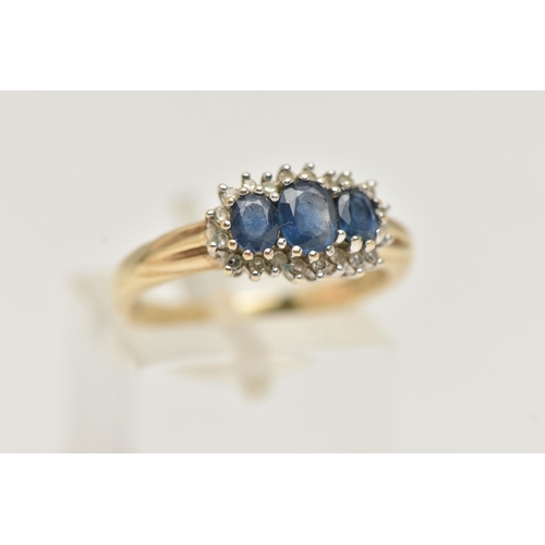 63 - A 9CT GOLD SAPPHIRE AND DIAMOND RING, designed as three graduated oval sapphires within a single cut... 