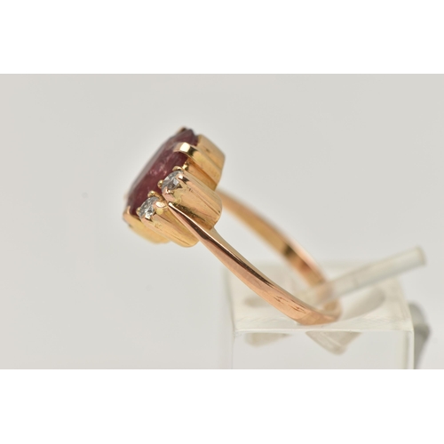 67 - A YELLOW METAL FIVE STONE RING, centering on an oval cut heavily fracture filled red corundum, in a ... 