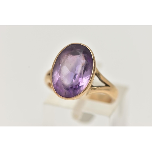 74 - A YELLOW METAL AMETHYST RING, large oval cut amethyst, measuring approximately length 15.2mm x width... 