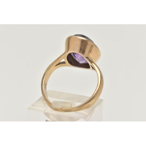 74 - A YELLOW METAL AMETHYST RING, large oval cut amethyst, measuring approximately length 15.2mm x width... 