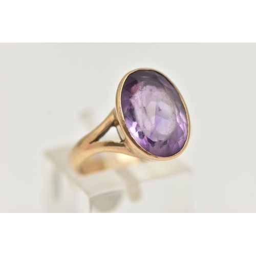 74 - A YELLOW METAL AMETHYST RING, large oval cut amethyst, measuring approximately length 15.2mm x width... 