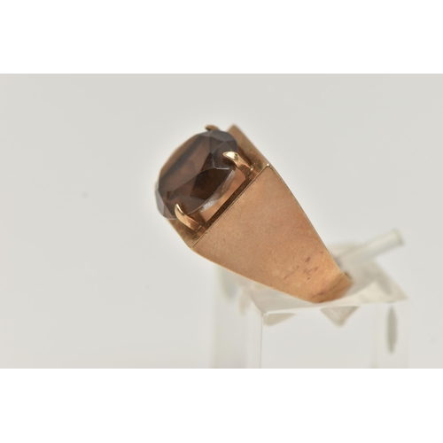 107 - A 9CT GOLD DRESS RING, a circular cut smoky quartz, four prong set in yellow gold, set in a square m... 