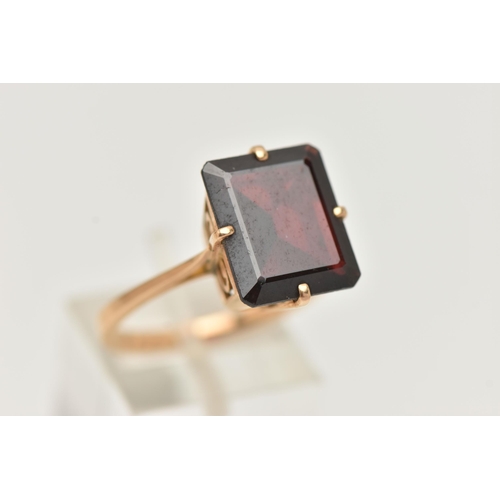 109 - A GARNET DRESS RING, a large rectangular cut garnet, approximate length 13mm x width 11mm, four pron... 