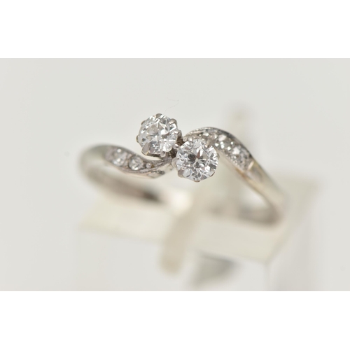 121 - A TWO STONE DIAMOND RING, two old cut diamonds prong set in white metal, flanked with four old cut d... 