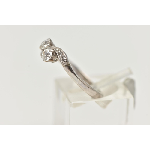 121 - A TWO STONE DIAMOND RING, two old cut diamonds prong set in white metal, flanked with four old cut d... 