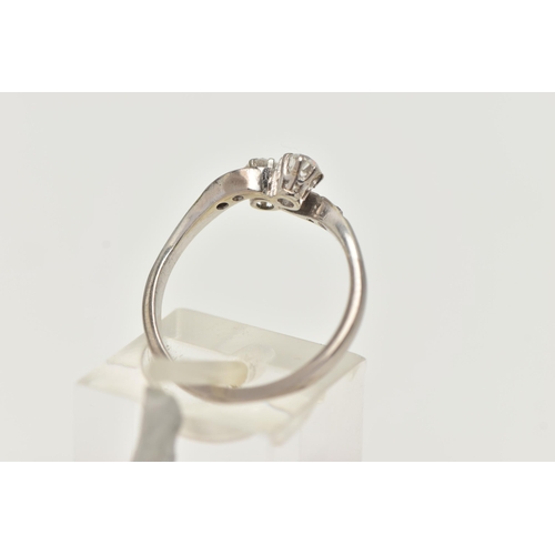 121 - A TWO STONE DIAMOND RING, two old cut diamonds prong set in white metal, flanked with four old cut d... 