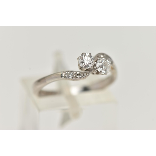 121 - A TWO STONE DIAMOND RING, two old cut diamonds prong set in white metal, flanked with four old cut d... 