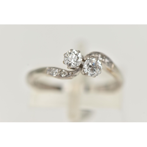 121 - A TWO STONE DIAMOND RING, two old cut diamonds prong set in white metal, flanked with four old cut d... 