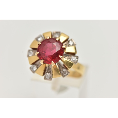 123 - A YELLOW METAL GEM SET DRESS RING, centering on a large circular cut garnet topped red paste doublet... 