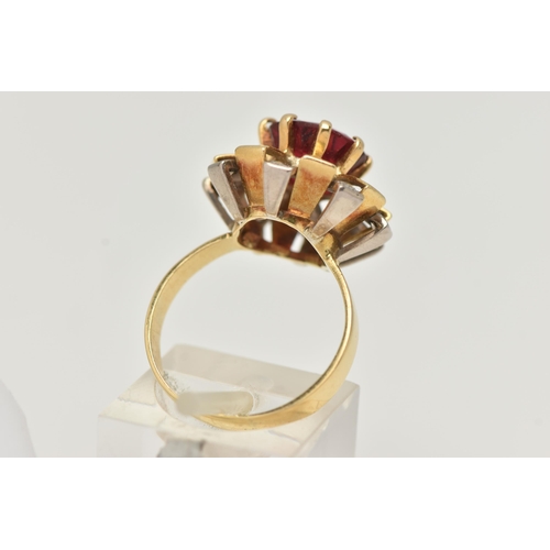 123 - A YELLOW METAL GEM SET DRESS RING, centering on a large circular cut garnet topped red paste doublet... 