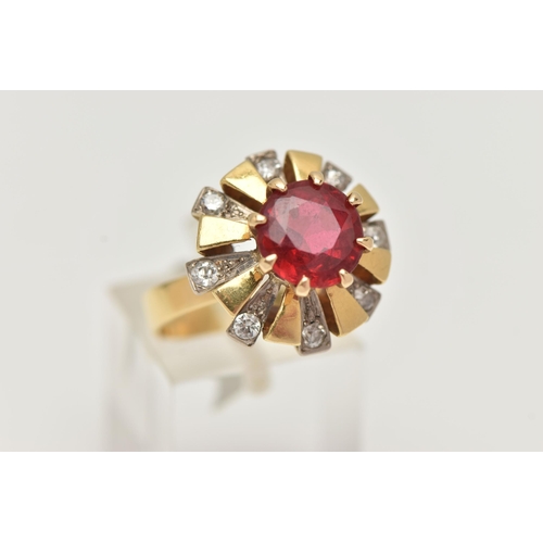 123 - A YELLOW METAL GEM SET DRESS RING, centering on a large circular cut garnet topped red paste doublet... 