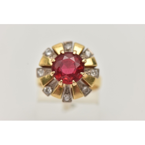 123 - A YELLOW METAL GEM SET DRESS RING, centering on a large circular cut garnet topped red paste doublet... 